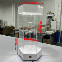 Vente en gros d'usine Vitrine rotative hexagonale en acrylique avec étagères rondes à niveaux, système d'éclairage LED supérieur et porte verrouillable