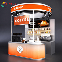 Kiosque à café en acier inoxydable argenté avec auvent LED circulaire, comptoir de point de vente nervuré, équipement de présentation, étagères et armoire