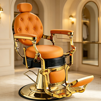 Fauteuil de barbier vintage en cuir capitonné orange avec cadre doré, fauteuil de salon hydraulique pour usage professionnel en salon de coiffure