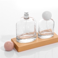 Vente en gros de flacons de parfum vides en verre transparent ovale de luxe de 50 ml et 100 ml avec atomiseur et couvercle sphérique