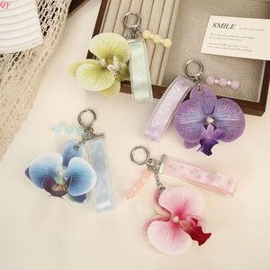 Llavero de PVC con flor de orquídea, diseño tierno, adornado con cuentas de perlas y un dije en forma de estrella; souvenir a - Product Image 2