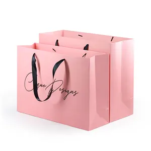 Precio competitivo de China elegante logotipo de marca personalizado de lujo vino Boutique compras bolsas de regalo de papel rosa con asas personalizadas