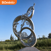 Sculpture en acier inoxydable poli miroir, cercles entrelacés, design poissons et oiseaux, grande œuvre d'art métallique moderne pour parc extérieur