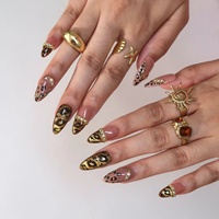Ongles à presser en acrylique de luxe motif léopard, base rose nude, ligne métallique dorée, strass irisés, forme amande, ongles élégants et audacieux