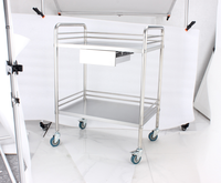 Chariot médical GINEE en acier inoxydable à 2 niveaux avec tiroir et poubelle pour clinique