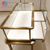 Vitrine à bijoux en verre LED de luxe avec support en or rose pour boutique de bijouterie, design personnalisé