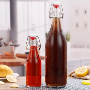 Yuvarlak şekilli özel logo içecek temizle 250ml 500ml 1000ml cam içme şişesi salıncak üst stoper ile