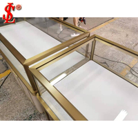 Vitrine de présentation de bijoux elliptique de luxe, aménagement de boutique, comptoir de table minimaliste en laiton, solution LED pour l'ensemble de la boutique