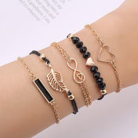Nouvelle montre pour femme avec cadran étoilé, montre à quartz tendance, montre-bracelet noire et 5 bracelets en forme de feuille et de cœur