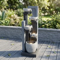 Fontaine d'eau extérieure contemporaine avec des bols à niveaux décalés et une colonne en faux pierre, idéale pour le jardin ou la terrasse
