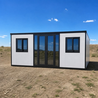 Maison conteneur pliable extensible blanche avec cadre noir et portes vitrées pour le glamping et le bureau de chantier