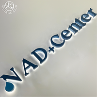 Enseigne lumineuse LED 3D personnalisée avec lettres bleues rétroéclairées, lettres en acier inoxydable miroir avec halo lumineux pour la réception de bureau