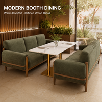Ensemble de salle à manger pour restaurant : chaises et tables, banquette rembourrée vert mousse, table en marbre blanc, piédestal doré, usage commercial