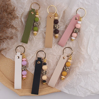 Porte-clés en cuir PU avec breloque de sac en silicone perlé imprimé léopard, pendentif de clé de voiture fait main, accessoire de mode féminin pour cadeau