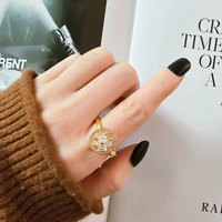 Bague rotative tendance en cuivre, motif moulin à vent à quatre feuilles, avec roue universelle dorée et zircon blanc, design ouvert, bague anti-stress