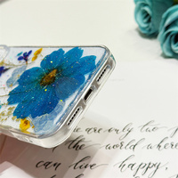 Coque antichoc transparente en TPU avec fleurs bleues séchées et paillettes pour iPhone 17, 16, 16e, 15, 14 Plus, 13, 12, 11 Pro Max