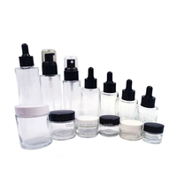 Botella de vidrio ámbar cilíndrica de hombro plano de gran venta, 20ml, 30ml, 60ml, con bomba dosificadora para loción/spray, impresión de superficie grabada con ácido