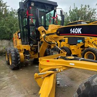 Niveleuse sur pneus Caterpillar 140K d'occasion, fabriquée au Japon/USA, avec moteur