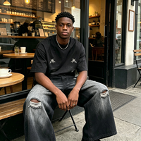 Culottes en jean noir déchiré pour hommes avec poches brodées, coupe large, style streetwear, vente en gros