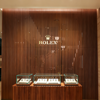 Armoire de présentation en verre luxueux avec cadre doré, éclairage LED, forme d'arc, dimensions personnalisables et résistante