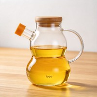 Bouteille en verre transparente en forme de gourde au design créatif avec poignée et couvercle, idéale pour la cuisine
