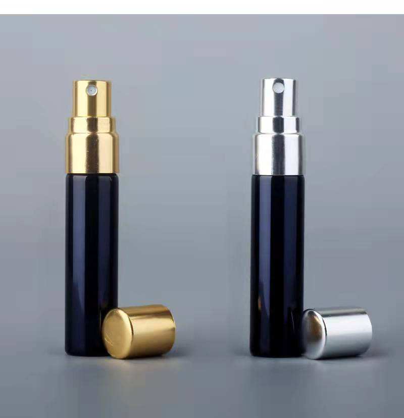 Black bottle with gold sprayer