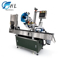 Etiqueteuse horizontale automatique pour contenants cylindriques instables, petits flacons, ampoules et tubes