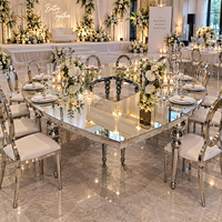 Table ronde blanche avec plateau circulaire, ouverture centrale large, pieds empilables en forme de boule, structure métallique, mobilier d'hôtel, salles de banquet
