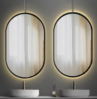 Miroir mural en verre avec cadre en aluminium de forme ovale au design de luxe Miroir de courtoisie mural désembué à commande tactile avec lumière LED