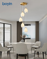 Lustre long de luxe en forme de fleur de magnolia, suspension nordique en porcelaine multi-têtes rotative pour escalier à plafond haut