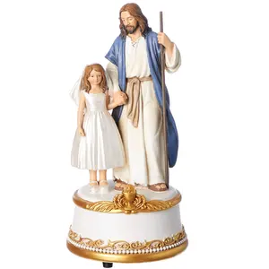 Resin Jesus cane with a girl standing on top of a music box