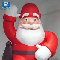 Père Noël gonflable géant personnalisé avec sac à dos pour la décoration de centres commerciaux en extérieur lors des événements de Noël