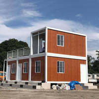 Maison conteneur détachable de 20 pieds, 2 étages, modulaire, préfabriquée en acier, étanche, avec panneaux imitation bois et balcon, pour dortoir de chantier