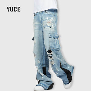 بنطلون جينز كارجو للرجال بلون أزرق فاتح، ممزق ومتعدد الجيوب، بتصميم واسع الساق ومرقع، مع تأثيرات الطلاء، مناسب لأزياء الشارع - Product Image 1