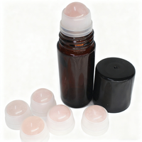 Flacon roll-on vide en verre ambré de 30 ml et 50 ml avec bille en quartz rose, emballé dans un carton sérigraphié