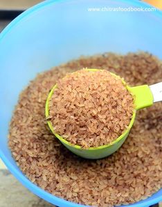Red Rice Grains in Green <b>Measuring</b> <b>Cup</b> Bulk Grain Container From Orissa <b>for</b> Cooking and <b>Baking</b> - Product Image 2