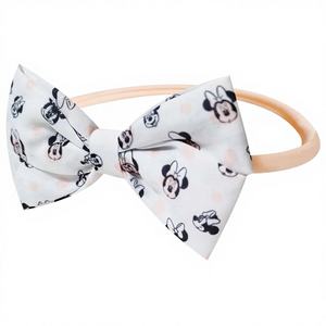 Ella. Accesorios al por Mayor Oficiales con Licencia para Bebés: Adorables Lazos para la Cabeza de Minnie, Elásticos y Suaves con Estampado - Product Image 1
