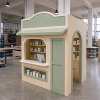 Équipement de divertissement commercial d'intérieur : Kiosque de jeu de rôle en forme de maison avec étagères de présentation pour projets de cafés ludiques