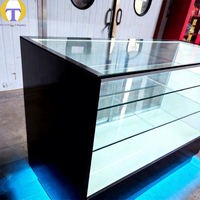Comptoir d'îlot de vente au détail moderne avec éclairage LED, verre trempé, construction en MDF, robuste et écologique pour les magasins de tabac