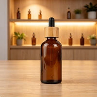 Flacon en verre ambré transparent de 100 ml avec compte-gouttes en bambou et bulbe noir brillant