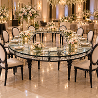 Table ronde blanche avec plateau circulaire, ouverture centrale large, pieds empilables en forme de boule, structure métallique, mobilier d'hôtel, salles de banquet