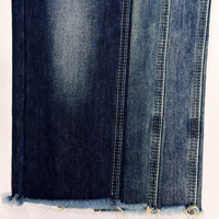 Tissu denim brut à faible rétrécissement (3 %), forme stable, texture slub non lavée, mélange coton-polyester, denim rigide