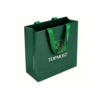 Sac en papier vert foncé personnalisé avec poignées en ruban et une ligne dorée pour l'emballage de détail commercial en gros