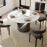Table à manger ronde moderne, surface aspect pierre foncée, piédestal sculptural en U pour salle à manger