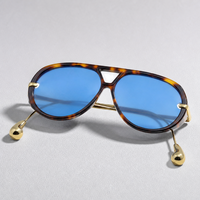 Lunettes de soleil ovales effet écaille de tortue avec verres bleus teintés, branches en métal doré, embouts en forme de larme, lunettes de mode, vente en gros et au détail