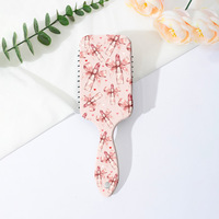 Brosse à cheveux démêlante portable style Coquette avec motif nœud léopard et coussin d'air, peigne de massage à palettes pour femmes