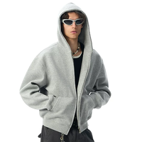 Hoodie court zippé coupe boxy pour homme en tissu molletonné floqué, avec épaules tombantes et broderie 3D, pour la vente en gros