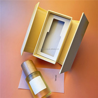 Emballage en papier rigide avec impression de conception de forme de logo de taille personnalisée Boîtes cadeaux de bouteille d'huile essentielle de parfum à ouverture bilatérale magnétique
