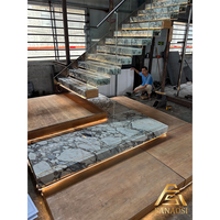Escalier flottant mural en bois avec supports dissimulés, marches en frêne massif et système de garde-corps à câble