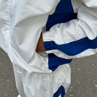 Survêtement personnalisé pour homme en nylon à rayures contrastées, veste zippée coupe-vent à col montant, pantalon large drapé, entraînement avec empiècements latéraux